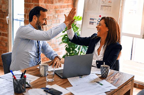 Business owners celebrating while working together